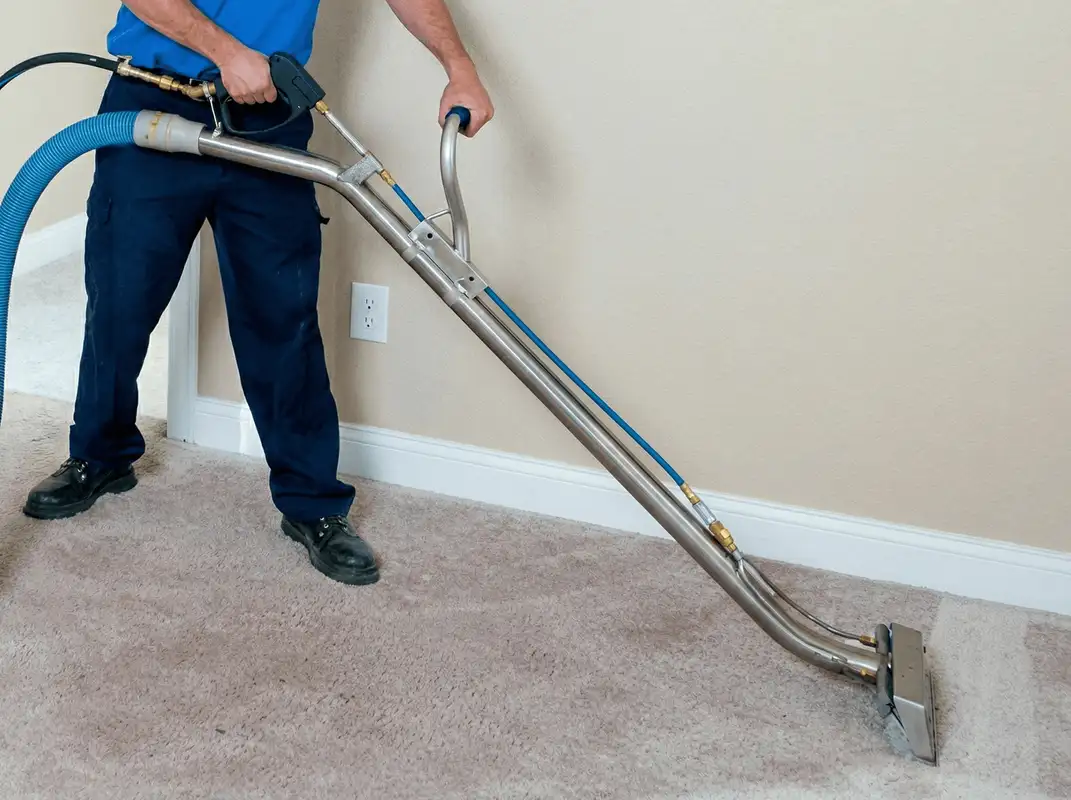 Professional operating a liquid removal machine on a carpeted floor in Worcester, MA