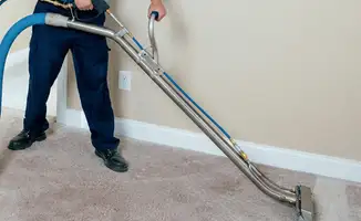 Professional operating a liquid removal machine on a carpeted floor in Worcester, MA